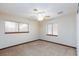 Bedroom with two windows, beige carpet, white walls and ceiling, and wood trim at 1050 Morgan Ln, Pahrump, NV 89060