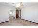 Bedroom with a closet and window, features neutral carpeting and decor with ceiling fan at 1050 Morgan Ln, Pahrump, NV 89060