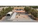 Bird's-eye-view exhibits this home with a tile roof, circular driveway, carport, and solar panels at 1050 Morgan Ln, Pahrump, NV 89060