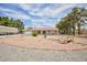 Charming single-story home with a red tile roof, desert landscaping, and attached two-car garage at 1050 Morgan Ln, Pahrump, NV 89060