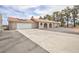 Single-story home featuring a tile roof, brick accents, solar panels, and an attached two-car garage at 1050 Morgan Ln, Pahrump, NV 89060
