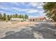 Spacious single-story home with a long driveway, carport, and low maintenance desert landscaping at 1050 Morgan Ln, Pahrump, NV 89060