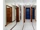 Bright hallway with mirrored walls, white tile flooring, and doors leading to various rooms at 1050 Morgan Ln, Pahrump, NV 89060
