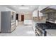 Well-equipped modern kitchen featuring stainless steel appliances, white cabinets and tile floor throughout at 1050 Morgan Ln, Pahrump, NV 89060