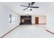 Bright living room with dark fireplace, skylights, shutters, and tile flooring at 1050 Morgan Ln, Pahrump, NV 89060