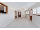 Open living room featuring tile flooring, bright windows, and a rustic-style wooden door at 1050 Morgan Ln, Pahrump, NV 89060