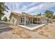 View of the back of house with large patio, overhang, and desert landscaping at 1050 Morgan Ln, Pahrump, NV 89060