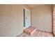 Close up shot of the covered porch entry, with a storm door and red brick step-up at 1050 Morgan Ln, Pahrump, NV 89060