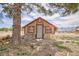 Well-maintained shed with painted trim, window and pathway to the house at 1050 Morgan Ln, Pahrump, NV 89060