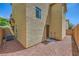 A low maintenance backyard featuring rock landscaping, a small patio, and a stucco wall at 10725 Wrigley Field Ave, Las Vegas, NV 89166