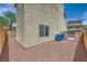 A low-maintenance backyard with rock landscaping and a neutral stucco exterior at 10725 Wrigley Field Ave, Las Vegas, NV 89166