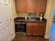 Convenient bar area with granite countertops, cabinetry, and a built-in wine cooler at 10725 Wrigley Field Ave, Las Vegas, NV 89166
