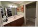 Bright bathroom with a large vanity, a framed mirror, and a shower over tub at 10725 Wrigley Field Ave, Las Vegas, NV 89166