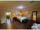 Primary bedroom featuring wood floors, neutral walls and an ensuite office space at 10725 Wrigley Field Ave, Las Vegas, NV 89166