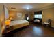 Bedroom featuring wood floors, neutral walls and a full length mirror at 10725 Wrigley Field Ave, Las Vegas, NV 89166