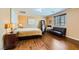 Bedroom with wood floors, natural light, and neutral colors give the room a relaxed feel at 10725 Wrigley Field Ave, Las Vegas, NV 89166