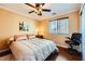 A bedroom with a ceiling fan, window, and furniture like bed, desk, chair, and nightstand at 10725 Wrigley Field Ave, Las Vegas, NV 89166