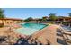 A large, inviting community pool with lounge chairs and well-maintained landscaping at 10725 Wrigley Field Ave, Las Vegas, NV 89166