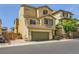 Attractive three-story home with a two-car garage, balcony, and meticulously kept landscaping at 10725 Wrigley Field Ave, Las Vegas, NV 89166