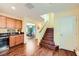 Hallway with dark wood floors, yellow walls, leading to the kitchen, dining room and the stairs at 10725 Wrigley Field Ave, Las Vegas, NV 89166