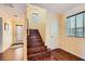 Hallway with dark wood floors, yellow walls, with stairs leading upstairs, and front door to the left at 10725 Wrigley Field Ave, Las Vegas, NV 89166