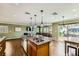 Open concept kitchen with granite counters, stainless appliances, and seamless flow to the living area at 10725 Wrigley Field Ave, Las Vegas, NV 89166