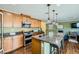 Modern kitchen with granite counters, stainless steel appliances, and a functional island with seating at 10725 Wrigley Field Ave, Las Vegas, NV 89166