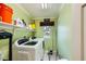 Functional laundry room with modern washer and dryer, plus storage shelves, maximizing space for household tasks at 10725 Wrigley Field Ave, Las Vegas, NV 89166