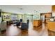 Open concept living room with hardwood floors, fireplace, and view of the kitchen and dining areas at 10725 Wrigley Field Ave, Las Vegas, NV 89166