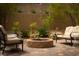 Backyard with a cozy seating area around a fire pit and desert landscaping at 12495 Point Sierra St, Las Vegas, NV 89138