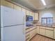 Corner kitchen featuring gas range, white appliances, and tile countertops at 1409 Santa Margarita St # G, Las Vegas, NV 89146