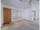 Spacious living room featuring wood door, large window and neutral carpet at 1409 Santa Margarita St # G, Las Vegas, NV 89146