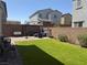Backyard boasting artificial turf, patio area, and privacy fence for outdoor relaxation at 1618 Dakota Group Ave, North Las Vegas, NV 89084
