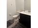 Bathroom with a dark vanity, a white countertop, a white toilet, and neutral flooring at 1618 Dakota Group Ave, North Las Vegas, NV 89084