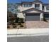 Two-story home with a brick driveway, a two-car garage, and well-maintained landscaping in front at 1618 Dakota Group Ave, North Las Vegas, NV 89084