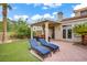 Inviting backyard features a covered patio, lounge chairs, and manicured lawn for outdoor enjoyment at 2010 Catalina Marie Ave, Henderson, NV 89074