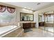 Bright bathroom with soaking tub, glass shower, travertine floors, and double vanity with granite counters at 2010 Catalina Marie Ave, Henderson, NV 89074