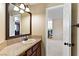 Bathroom vanity with granite countertop, wood cabinets and view into the hallway at 2010 Catalina Marie Ave, Henderson, NV 89074