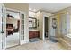 A luxurious bathroom with a walk-in shower, soaking tub, and separate vanity areas providing a spa-like experience at 2010 Catalina Marie Ave, Henderson, NV 89074