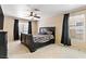 Spacious bedroom features a king bed, carpet floors, and natural light from two windows at 2010 Catalina Marie Ave, Henderson, NV 89074