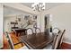 Open dining area features a large dining table, hardwood floors, and staircase with iron railings at 2010 Catalina Marie Ave, Henderson, NV 89074