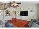 Cozy living room featuring hardwood floors, a wet bar and a staircase with iron railings at 2010 Catalina Marie Ave, Henderson, NV 89074