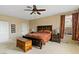 Large carpeted bedroom featuring dark wood furnishings and a ceiling fan for a cozy atmosphere at 2010 Catalina Marie Ave, Henderson, NV 89074
