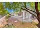 Beautiful backyard featuring a covered patio, mature trees, lovely landscaping, and rock features at 2154 Idaho Falls Dr, Henderson, NV 89044