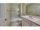 This bathroom offers a shower-tub combo with sliding glass doors, a bright countertop, and tile floors at 2154 Idaho Falls Dr, Henderson, NV 89044