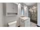 Updated bathroom featuring a granite countertop, stylish vanity, and glass-enclosed shower with gray tile at 2154 Idaho Falls Dr, Henderson, NV 89044