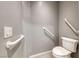 Accessible bathroom featuring support bars and a toilet, designed with safety and convenience in mind at 2154 Idaho Falls Dr, Henderson, NV 89044
