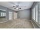 Spacious bedroom with a ceiling fan, large window with shutters, and a door leading to the bathroom at 2154 Idaho Falls Dr, Henderson, NV 89044