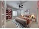 Serene bedroom featuring a plush bed, ample storage with built-in shelving, and soft lighting for a cozy ambiance at 2154 Idaho Falls Dr, Henderson, NV 89044