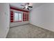 Bright bedroom featuring a ceiling fan, and a built-in bookshelf and storage underneath the window at 2154 Idaho Falls Dr, Henderson, NV 89044